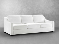 A modern white couch positioned against a sleek gray wall, creating a stylish and minimalist living space