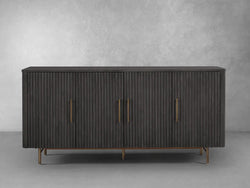 A dark wood sideboard featuring two elegant brass handles, showcasing a blend of sophistication and functionality