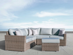 Stylish wicker sectional set for outdoor use, complete with comfortable cushions for added relaxation