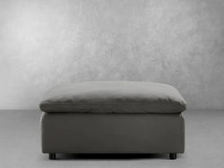 A grey ottoman positioned next to a black ottoman, showcasing a stylish contrast in color and design