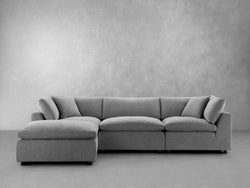 A gray sectional couch adorned with decorative pillows, creating a cozy and inviting living space