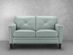 A light blue leather couch featuring a stylish wooden base, offering a modern and elegant seating option for any space