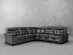 A gray leather sectional sofa featuring a reclining seat, offering comfort and modern style for any living space