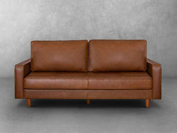 A brown leather sofa featuring elegant wooden legs, showcasing a blend of comfort and style in a modern living space