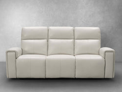 A modern white leather sofa is prominently displayed, showcasing its sleek design and contemporary style