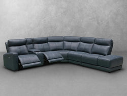 A modern blue leather sectional sofa displayed in a stylish living room setting, showcasing its sleek design and comfort