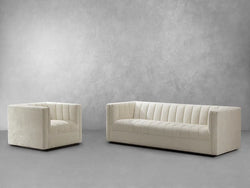 Two white sofas and a chair arranged in front of a wall, creating a cozy and inviting seating area