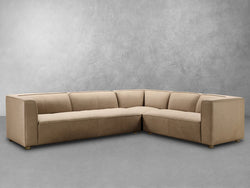 A beige leather sectional sofa, elegantly designed, showcasing its smooth texture and modern style in a cozy living space