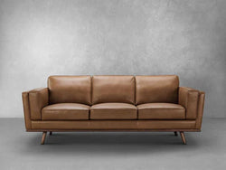 A contemporary tan leather sofa showcasing a minimalist design, ideal for enhancing modern interior decor