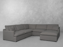 A spacious sectional couch featuring a comfortable chaise for relaxation and seating in a modern living room setting.