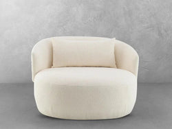 A white chair adorned with a soft pillow, creating a cozy and inviting seating area.