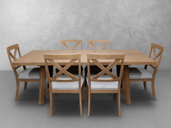 A wooden dining table surrounded by six chairs, elegantly arranged for a meal setting