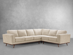 A beige fabric sectional sofa arranged in a cozy living room setting, providing comfort and style