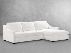 A modern white sectional couch featuring a comfortable chaise for relaxation and stylish seating in a living space