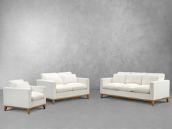 A stylish white sofa, chair, and ottoman set arranged elegantly in a modern living space