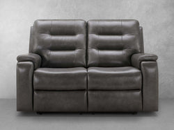 A Black leather reclining sofa is prominently displayed in the image, showcasing its elegant design and comfort